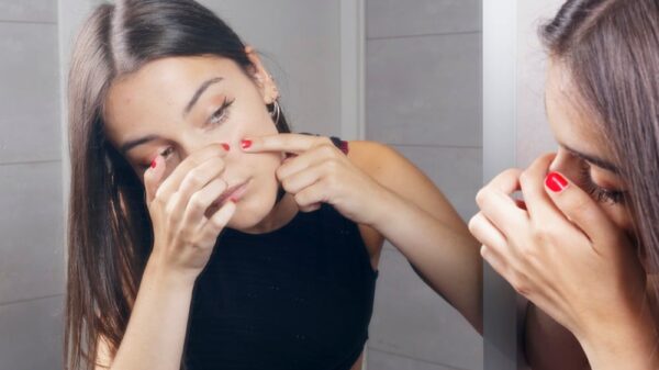 surprised young woman finding acne on her face picture id831176750