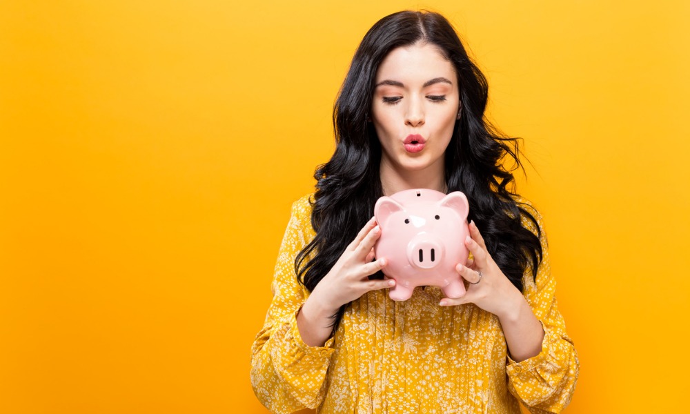 young woman with a piggy bank picture id857674990